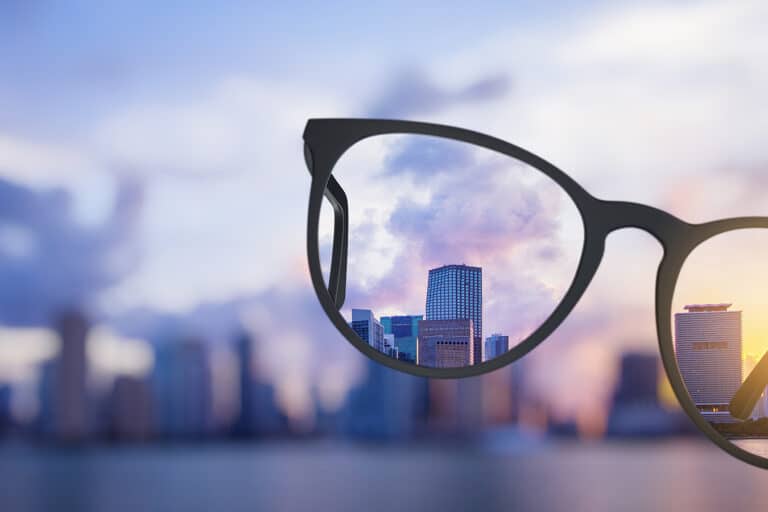 Modern bright city view through eyeglasses
