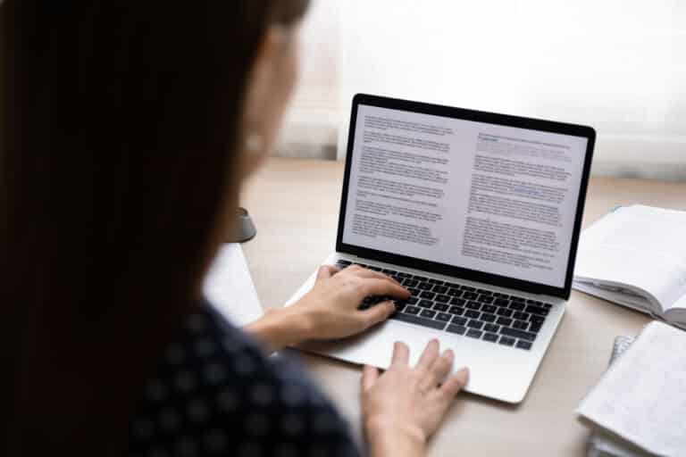 Focused young businesswoman working on electronic documents